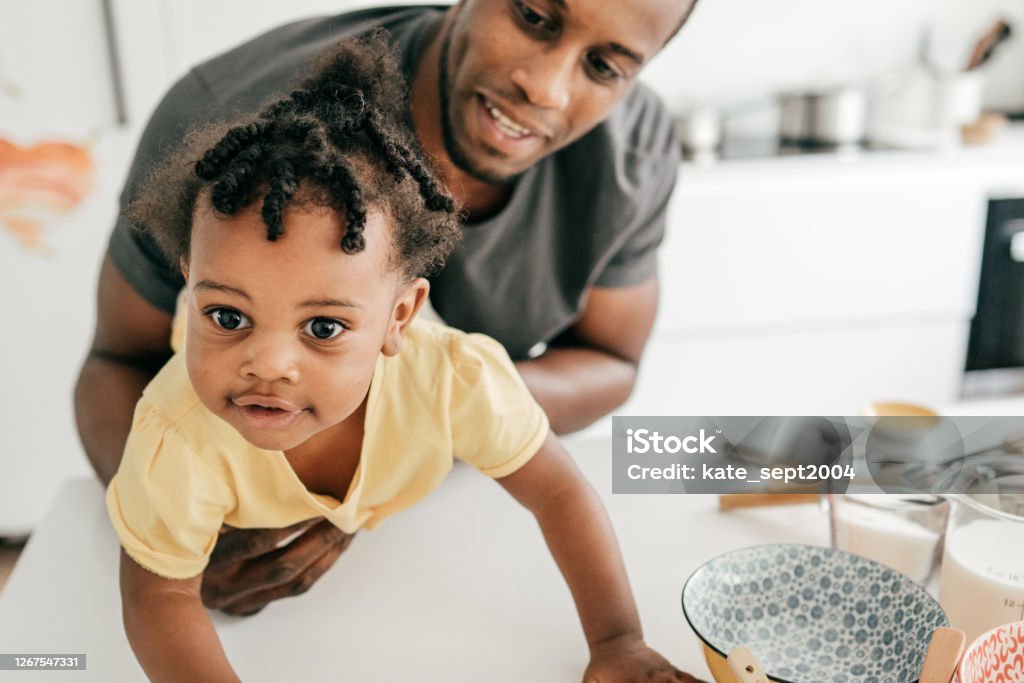 Dad taking care of his baby at home 30-34 Years Stock Photo