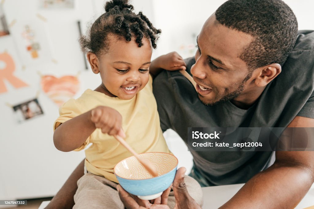Dad and toddler eating snacks Toddler Stock Photo