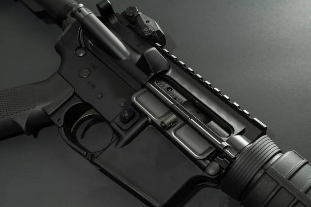 AR – 15 Black AR-15 laying on black background. armory photos stock pictures, royalty-free photos & images