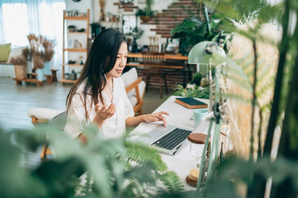 istock asian woman working at home 1267548426