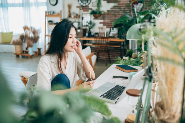 istock asian woman working at home 1267548506