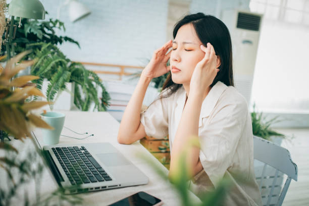 istock Asian woman struggling with using laptop at home 1267548835