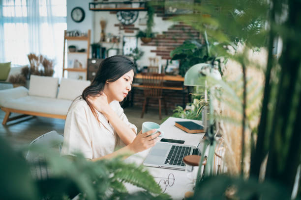 istock Asian woman struggling with using laptop at home 1267548912