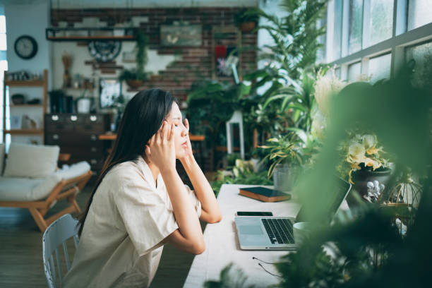 istock Asian woman struggling with using laptop at home 1267548914