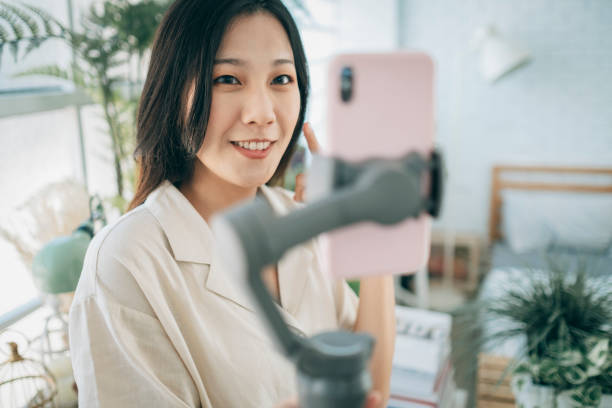 istock Asian woman using steady cam with smartphone 1267548965