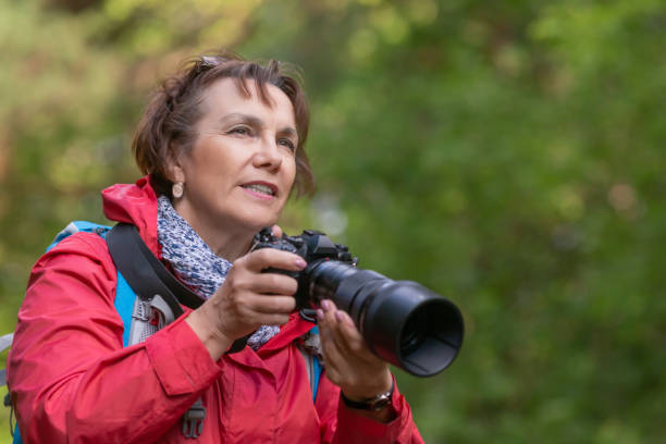 istock Senior woman make a photo in forest 1267551806