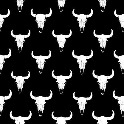 Vector seamless pattern of white steer skulls on a black background.