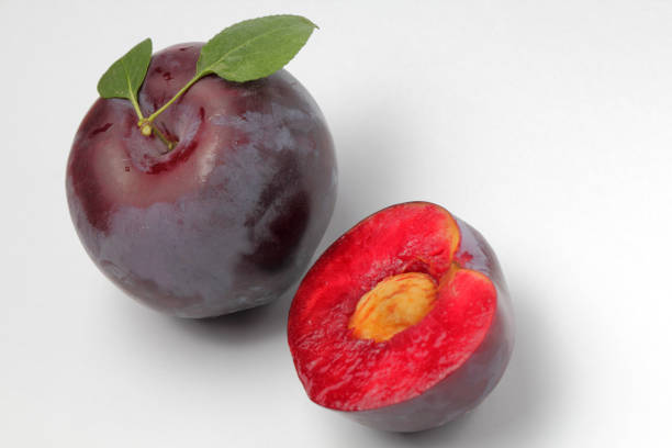 istock Large plum and a half on a white background, bright natural colors, high contrast. 1267552780