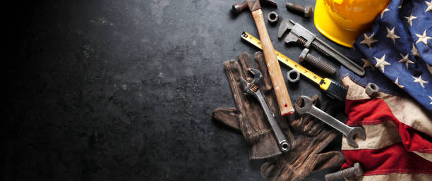 istock Construction and manufacturing tools with patriotic US, USA, American flag on dark black background 1267553287