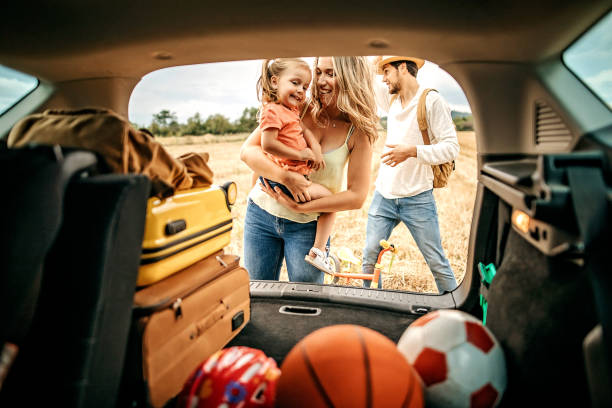 Let's play Parents with kid going to picnic with car car trunk stock pictures, royalty-free photos & images