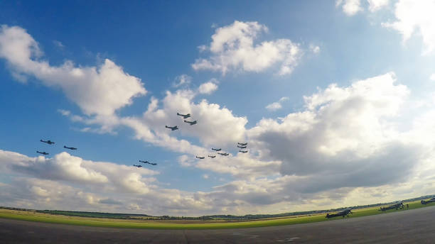 Duxford, Cambridgeshire / UK - September 2014: A flight of World War II era Supermarine Spitfires perform a fly past. The Spitfire was the Royal Air Forces most iconic aircraft during the Battle of Britain.
