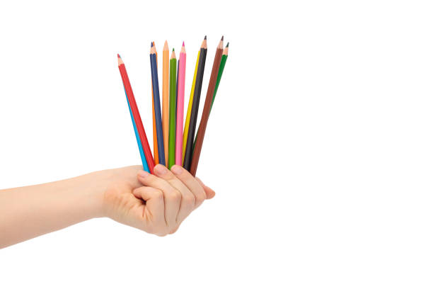istock Multi-colored pencils for drawing in a female hand. 1267558733