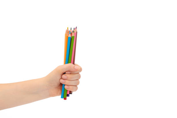 istock Multi-colored pencils for drawing in a female hand. 1267558734