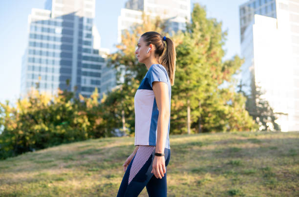istock Woman jogging in public park. 1267558911
