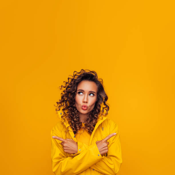 istock Beautiful woman pointing at copy space with crossed hands 1267560108
