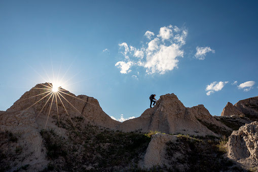 Young men hiking the mountains of the Badlands National Park in South Dakota, USA