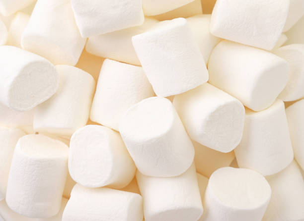 istock Chewing marshmallow white, background. The view from top 1267561024