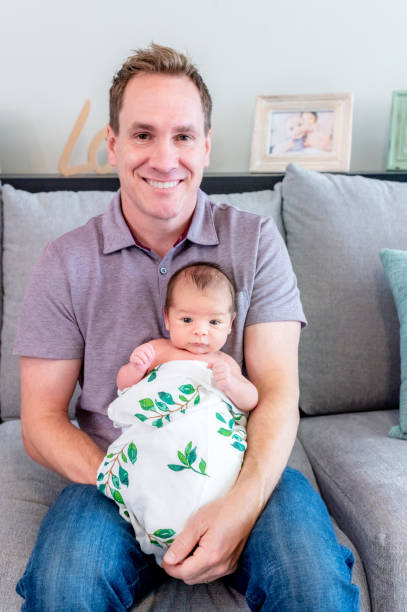 istock New father proudly holds his newborn 1267561165