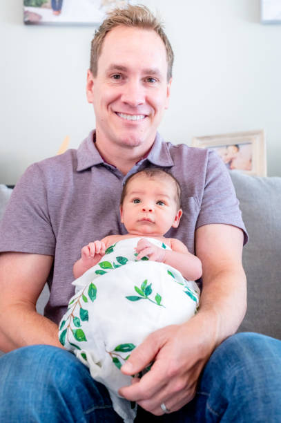 istock New father proudly holds his newborn 1267561166
