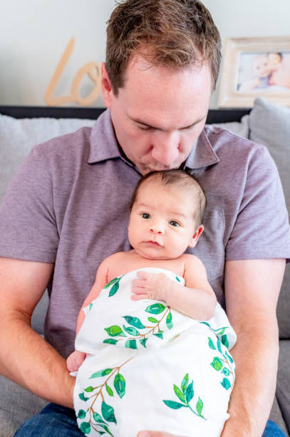 istock New father proudly holds his newborn 1267561328