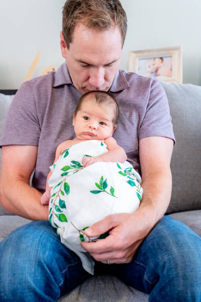 istock New father proudly holds his newborn 1267561391
