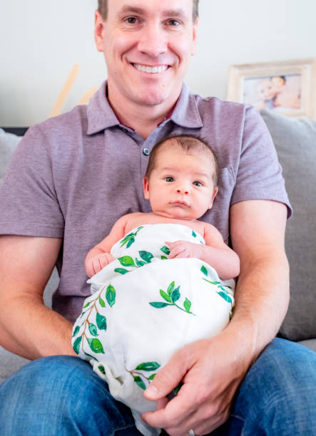 istock New father proudly holds his newborn 1267561393
