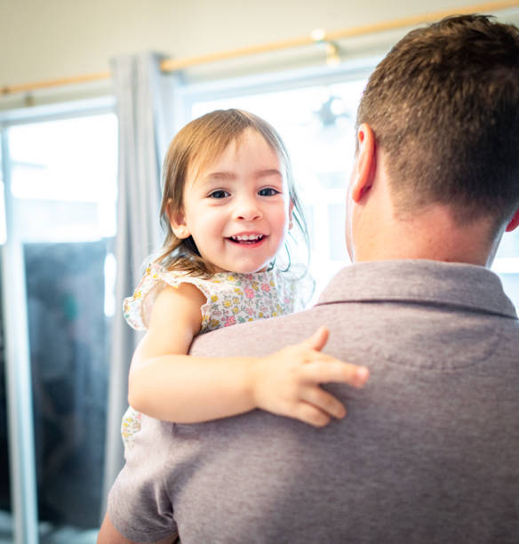 istock Father holds happy toddler daughter 1267561695