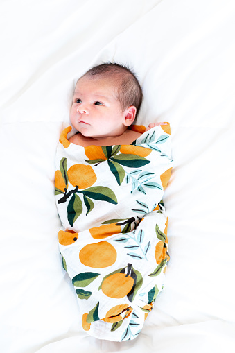 Adorable newborn baby in colorful blanket