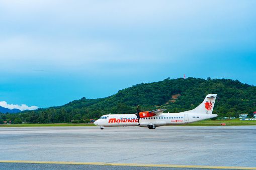 The PR PDO propeller-driven passenger aircraft prepares for takeoff at the airport on the island of Langkawi. Langkawi, Malaysia - 07.18.2020