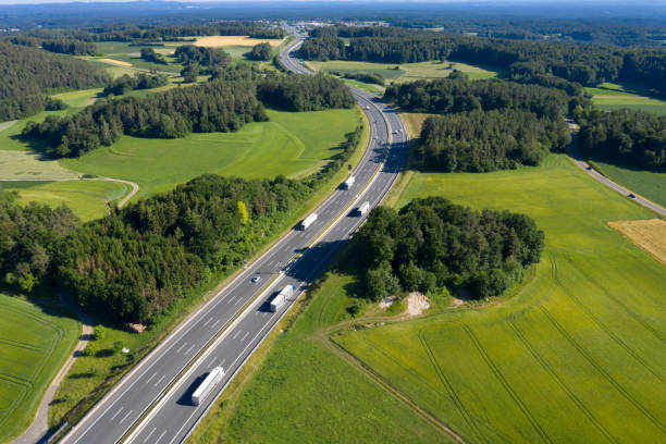 istock Multiple Lane Highway with Semi Trucks from Above 1267565887