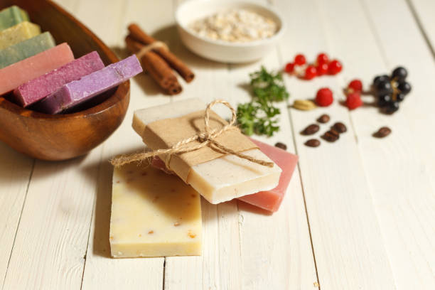 istock Colored natural soap and ingredients for cooking on a white wooden surface. Horizontal orientation with space 1267567228