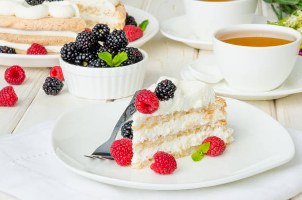 istock Layer almond cake with cream, fresh raspberries, blackberries and mint leaves on top. 1267567461