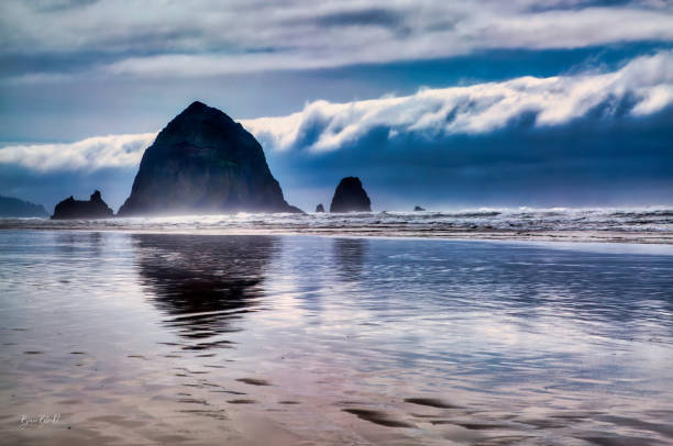 istock Mirror reflections of Haystack Rock at Cannon Beach 1267570206