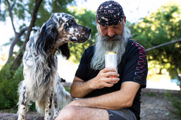istock A man looking at a can of drink while his dog is looking at him 1267571858