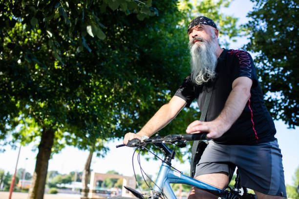 istock A man with a long gray beard on a bicycle 1267571868