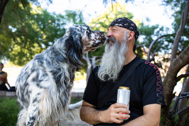 A dog sniffing a man's nose