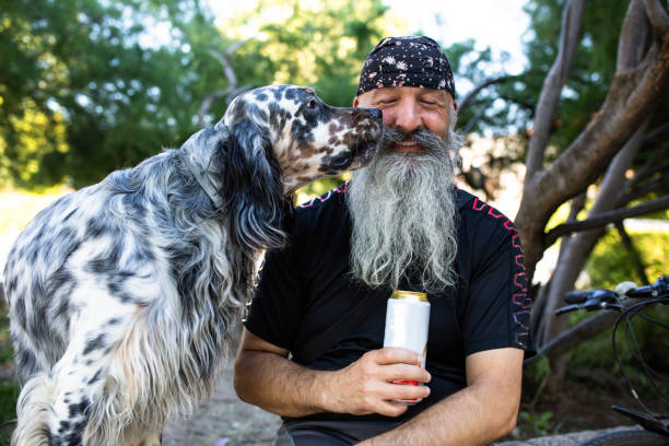 istock A man with a beard smiling while a dog is sniffing his face 1267571887