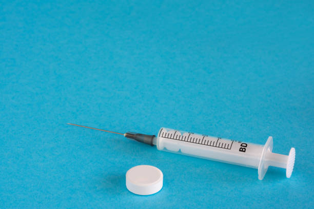 istock A tablet and a syringe on a blue background, with copy space. Medicine Concept. 1267573810
