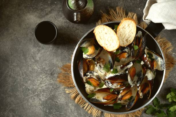 istock Shell mussels in creamy garlic cheese sauce. 1267573927