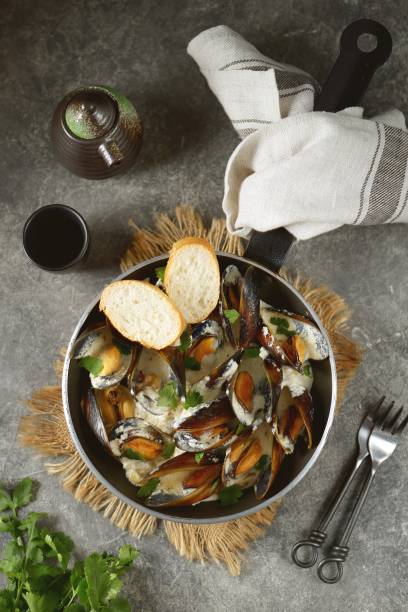 istock Shell mussels in creamy garlic cheese sauce. 1267573944