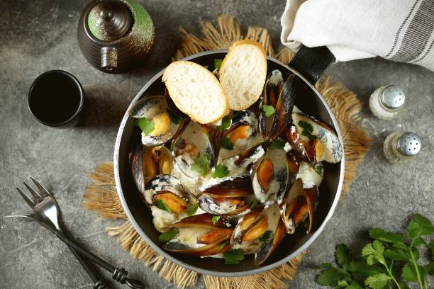 istock Shell mussels in creamy garlic cheese sauce. 1267573948
