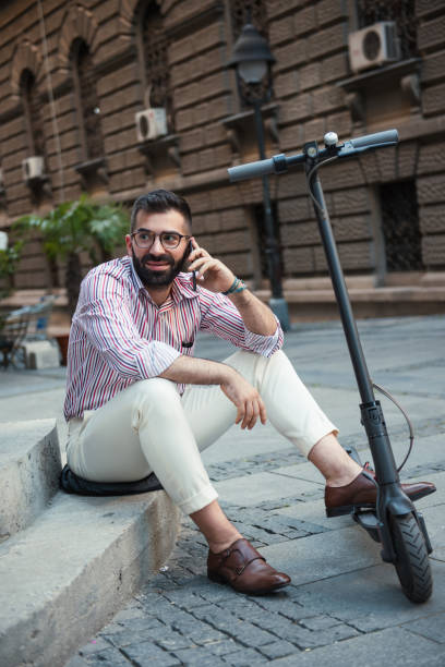 istock Man taking a break after long ride on his electrical scooter 1267577403