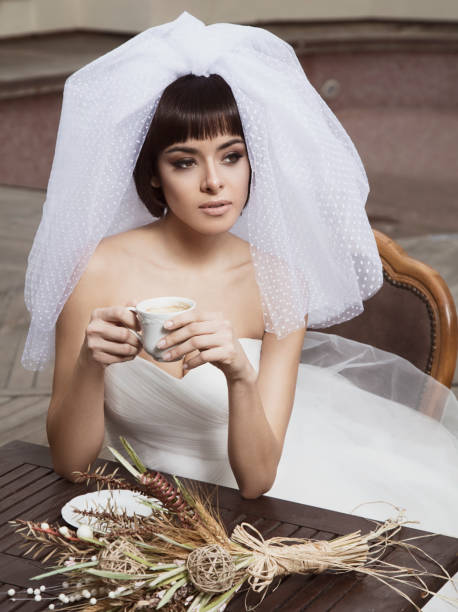 istock Beautiful bride looks great with her veil while relaxing. 1267578247
