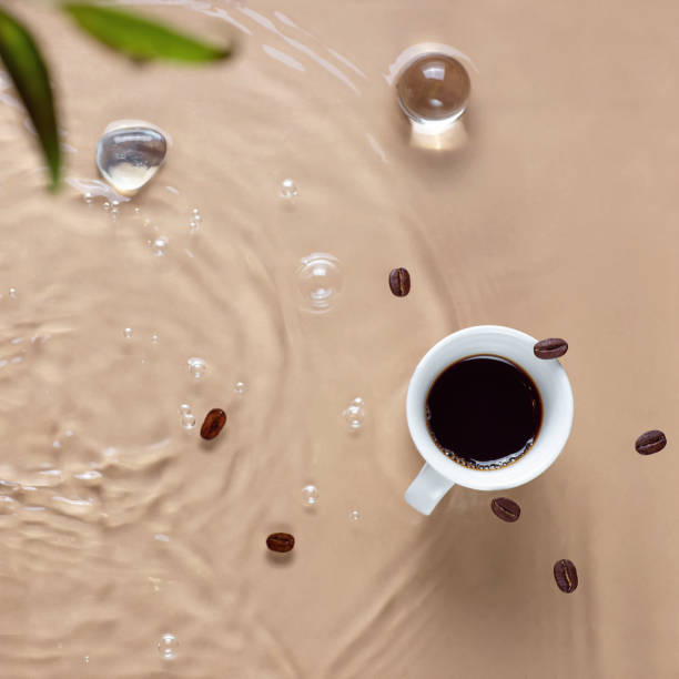 Hot coffee is splashing in cup. water and beans are blending