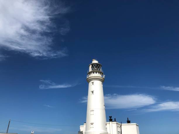 Working all white Lighthouse again deep blue skyline