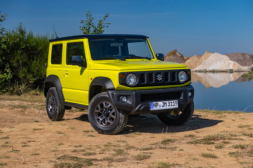 Berlin, Germany - 21 August, 2020: Suzuki Jimny on a road near the lake. This vehicle is used to get in extremely hard areas.
