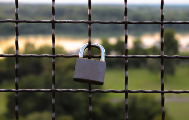 istock Lock on metal wire on a blurred nature background 1267579342