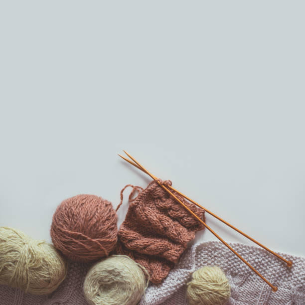 istock Woolen yarn and knitting needles on grey backdrop 1267579348