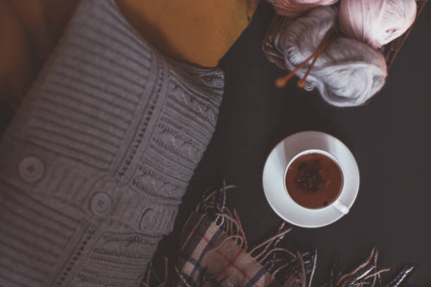 istock Woolen yarn and knitting needles in basket and tea 1267579375