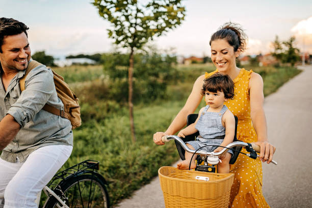 We are going to one more circle Happy family driving on bicycles in nature cargo bike photos stock pictures, royalty-free photos & images